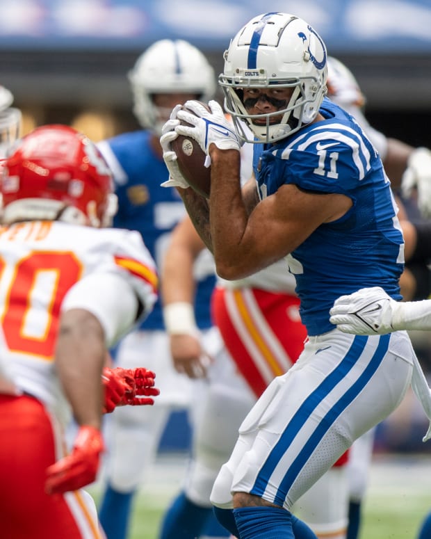 Sep 25, 2022; Indianapolis, Indiana, USA; Indianapolis Colts wide receiver Michael Pittman Jr. (11) catches a pass in front of Kansas City Chiefs linebacker Darius Harris (47) during the second quarter at Lucas Oil Stadium.