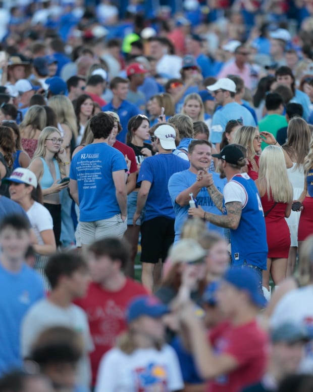 Fans storm the field at David Booth Kansas Memorial Stadium after Kansas defeated Iowa State 14-11