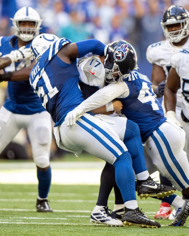 Oct 2, 2022; Indianapolis, Indiana, USA; Tennessee Titans quarterback Ryan Tannehill (17) is sacked by Indianapolis Colts defensive end Kwity Paye (51) and Indianapolis Colts linebacker Zaire Franklin (44) during the second half at Lucas Oil Stadium. Titans won 24 to 17.
