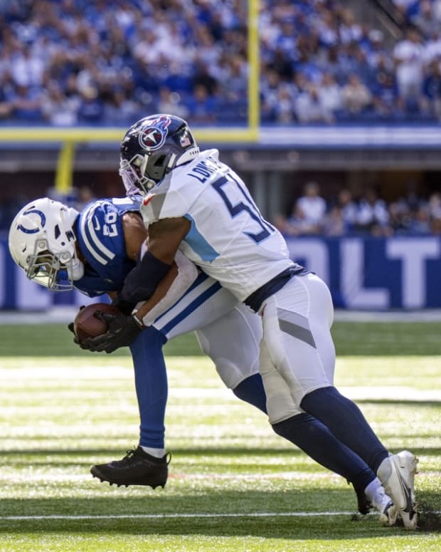 Indianapolis Colts running back Jonathan Taylor (28) is tackled by Tennessee Titans linebacker David Long Jr. (51) during the second quarter at Lucas Oil Stadium.