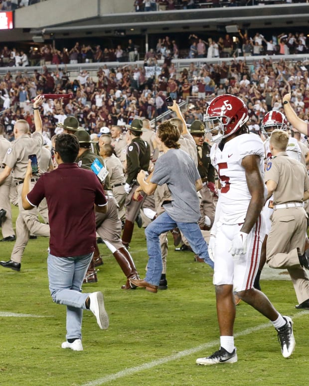 Alabama defensive back Jalyn Armour-Davis (5) leaves the field as Texas A&M fans storm the field after a game-winning field goal as time expired at Kyle Field. Texas A&M defeated Alabama 41-38