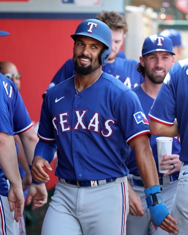 Oct 2, 2022; Anaheim, California, USA; Texas Rangers second baseman Marcus Semien (2) smiles in the dugout after scoring a home run by shortstop Corey Seager (5) in the fifth inning against the Los Angeles Angels at Angel Stadium. Mandatory Credit: Kiyoshi Mio-USA TODAY Sports