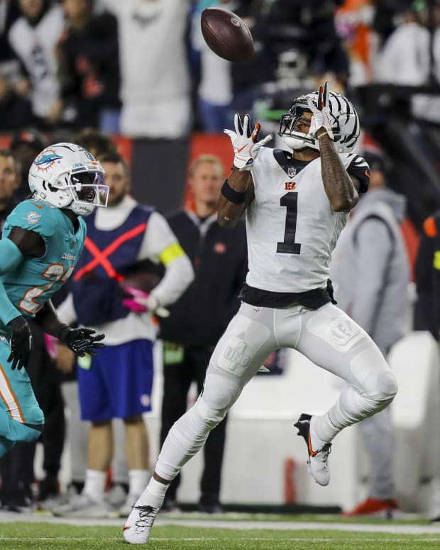 Sep 29, 2022; Cincinnati, Ohio, USA; Cincinnati Bengals wide receiver Ja'Marr Chase (1) catches a pass against Miami Dolphins cornerback Keion Crossen (27) in the second half at Paycor Stadium. Mandatory Credit: Katie Stratman-USA TODAY Sports