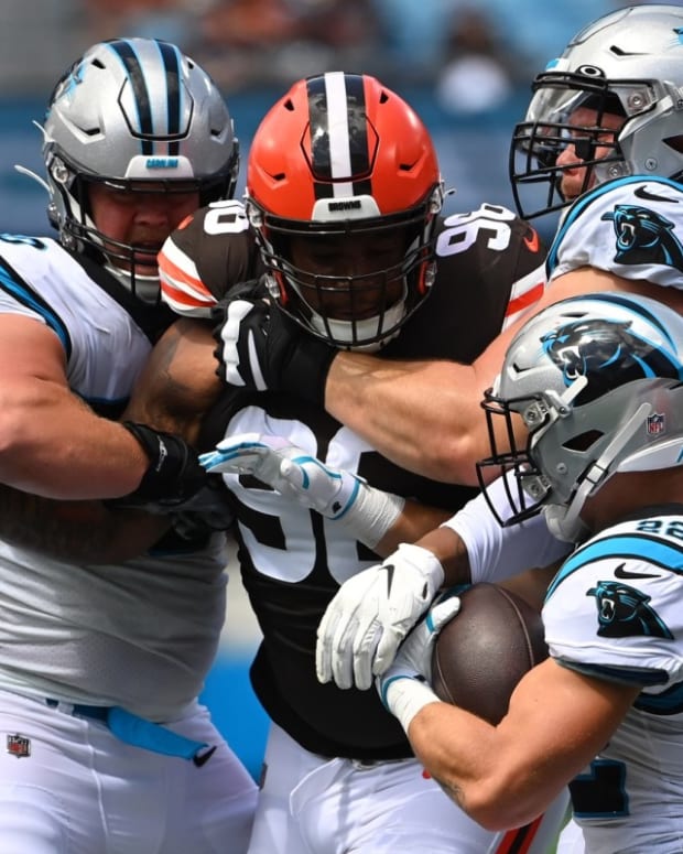 Sep 11, 2022; Charlotte, North Carolina, USA; Carolina Panthers running back Christian McCaffrey (22) with the ball as offensive tackle Brady Christensen (70) and guard Pat Elflein (60) block and Cleveland Browns defensive tackle Jordan Elliott (96) defends in the second quarter at Bank of America Stadium. Mandatory Credit: Bob Donnan-USA TODAY Sports
