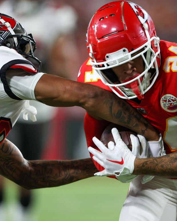 Oct 2, 2022; Tampa, Florida, USA; Tampa Bay Buccaneers cornerback Carlton Davis III (24) attempts to strip the ball from Kansas City Chiefs wide receiver Skyy Moore (24) in the third quarter at Raymond James Stadium. Mandatory Credit: Nathan Ray Seebeck-USA TODAY Sports