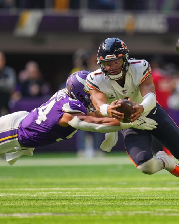 Oct 9, 2022; Minneapolis, Minnesota, USA; Chicago Bears quarterback Justin Fields (1) dives for a first down against the Minnesota Vikings linebacker Eric Kendricks (54) in the third quarter at U.S. Bank Stadium. Mandatory Credit: Brad Rempel-USA TODAY Sports