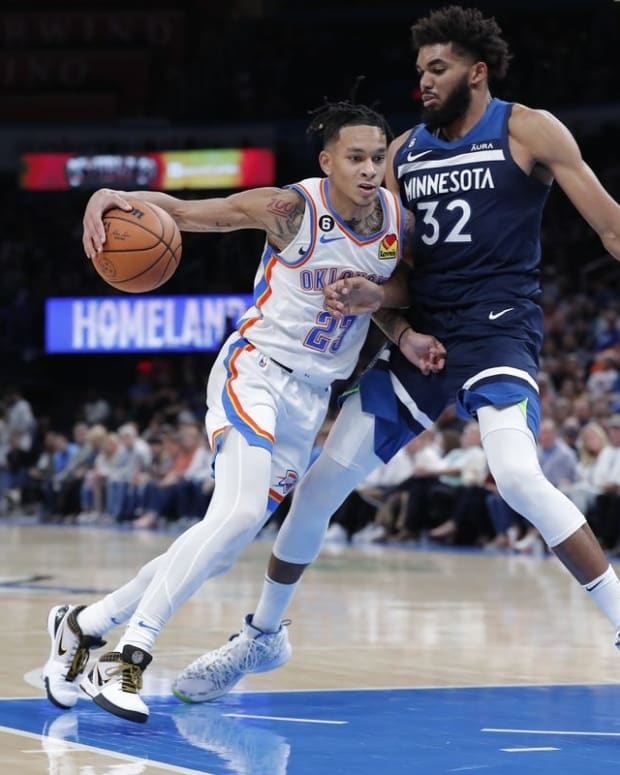 Oct 23, 2022; Oklahoma City, Oklahoma, USA; Oklahoma City Thunder guard Tre Mann (23) is defended by Minnesota Timberwolves center Karl-Anthony Towns (32) on a drive to the basket during the second half at Paycom Center. Minnesota won 116-106. Mandatory Credit: Alonzo Adams-USA TODAY Sports
