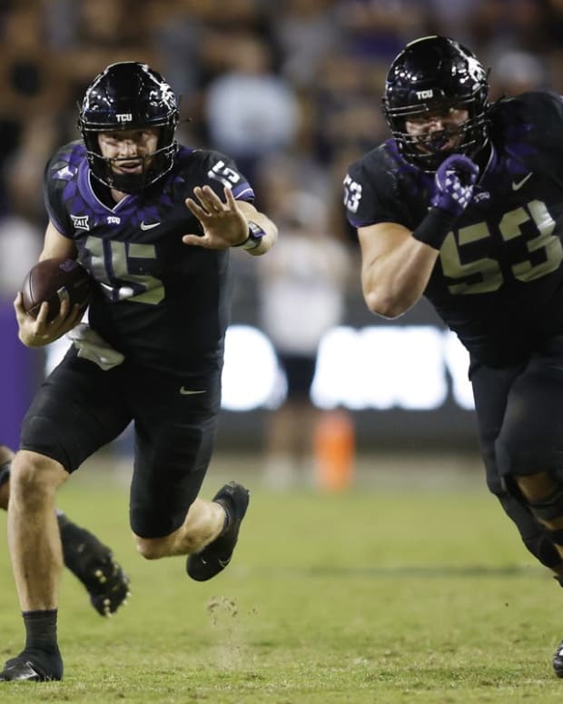 Oct 22, 2022; Fort Worth, Texas, USA; TCU Horned Frogs quarterback Max Duggan (15) runs for a first down as guard John Lanz (53) looks to block against the Kansas State Wildcats at Amon G. Carter Stadium. Mandatory Credit: Tim Heitman-USA TODAY Sports