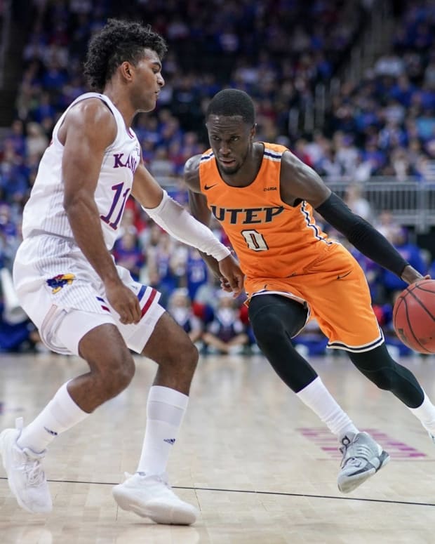 Dec 7, 2021; Kansas City, Missouri, USA; UTEP Miners guard Souley Boum (0) dribbles the ball as Kansas Jayhawks guard Remy Martin (11) defends during the game at T-Mobile Center. Mandatory Credit: Denny Medley-USA TODAY Sports
