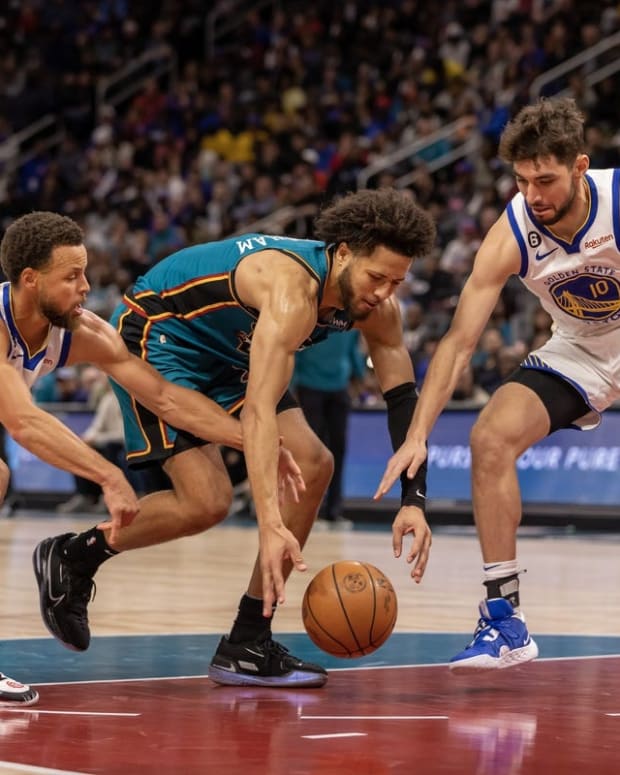 Oct 30, 2022; Detroit, Michigan, USA; Detroit Pistons guard Cade Cunningham (2) battles for the loose ball with Golden State Warriors guard Stephen Curry (30) and guard Ty Jerome (10) during the second half at Little Caesars Arena. Mandatory Credit: David Reginek-USA TODAY Sports