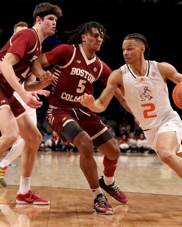 Mar 10, 2022; Brooklyn, NY, USA; Miami Hurricanes guard Isaiah Wong (2) drives to the basket against Boston College Eagles forward Quinten Post (12) and guard DeMarr Langford Jr. (5) during the second half at Barclays Center. Mandatory Credit: Brad Penner-USA TODAY Sports