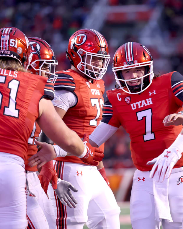 Utah Utes quarterback Cameron Rising (7) celebrates a touchdown with the offensive line in a game against the Arizona Wildcats during the second quarter at Rice-Eccles Stadium.