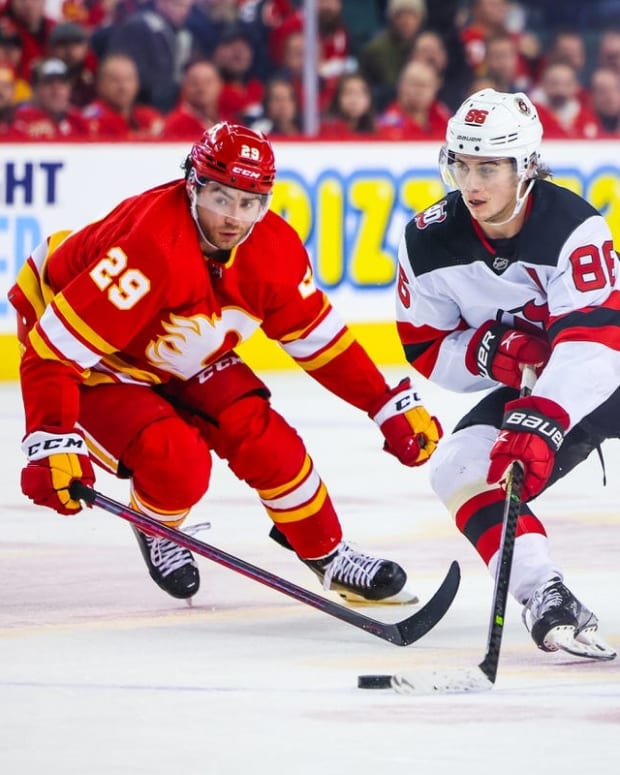 Nov 5, 2022; Calgary, Alberta, CAN; New Jersey Devils center Jack Hughes (86) controls the puck against Calgary Flames center Dillon Dube (29) during the third period at Scotiabank Saddledome. Mandatory Credit: Sergei Belski-USA TODAY Sports