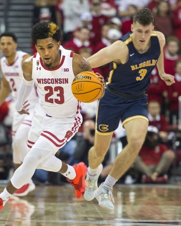 Oct 30, 2022; Madison, Wisconsin, USA; Wisconsin Badgers Chucky Hepburn (23) dribbles down the court against UW-Eau Claire Blugolds Spencer Page (3) during the second half at the Kohl Center. Mandatory Credit: Kayla Wolf-USA TODAY Sports