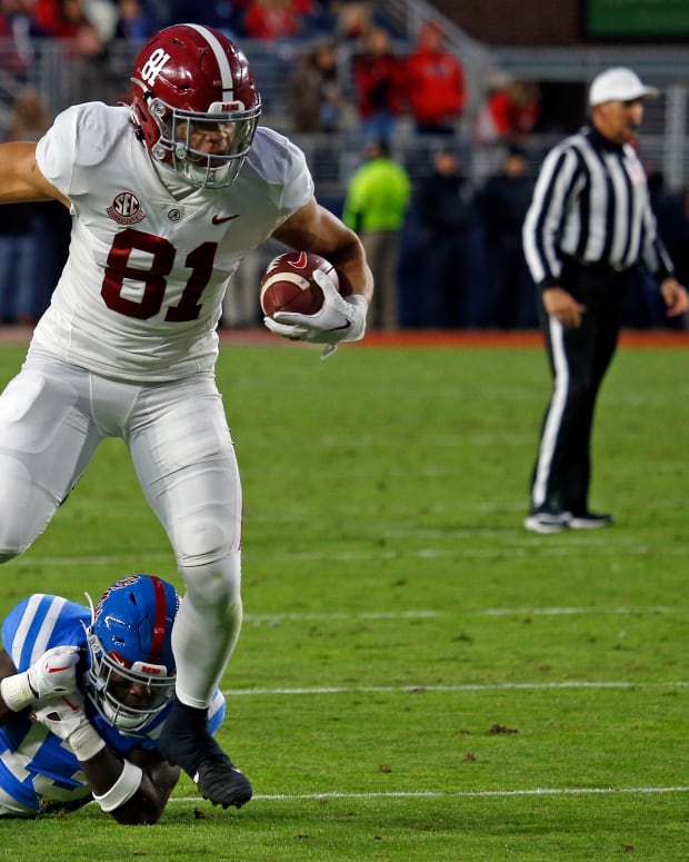 Alabama Crimson Tide tight end Cameron Latu (81) breaks a tackle attempt by Mississippi Rebels defensive back Ladarius Tennison (13) during the second half at Vaught-Hemingway Stadium.