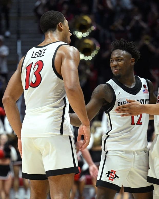 Nov 11, 2022; San Diego, California, USA; San Diego State Aztecs forward Jaedon LeDee (13) celebrates with guard Darrion Trammell (12) and guard Matt Bradley (20) after defeating the Brigham Young Cougars at Viejas Arena. Mandatory Credit: Orlando Ramirez-USA TODAY Sports