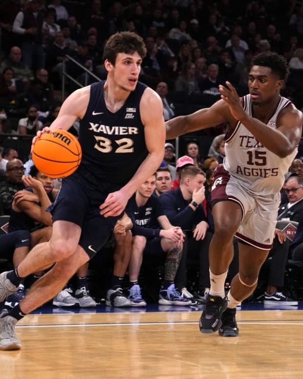 Mar 31, 2022; New York, New York, USA; Xavier Musketeers forward Zach Freemantle (32) dribbles the ball abasing Texas A&amp;M Aggies forward Henry Coleman III (15) during the second half of the NIT college basketball finals at Madison Square Garden. Mandatory Credit: Gregory Fisher-USA TODAY Sports