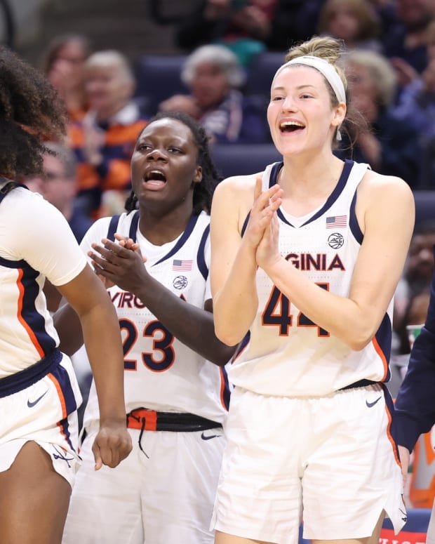The Virginia women's basketball team celebrates on the bench during a win over Wake Forest at John Paul Jones Arena.