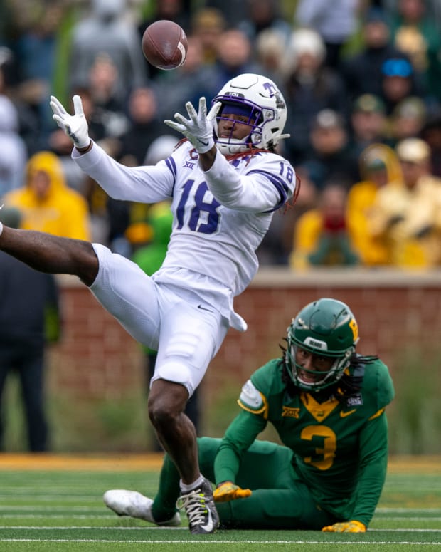 Nov 19, 2022; Waco, Texas, USA; TCU Horned Frogs wide receiver Savion Williams (18) catches a pass for a first down as TCU Horned Frogs safety Mark Perry (3) defends during the second half at McLane Stadium. Mandatory Credit: Jerome Miron-USA TODAY Sports
