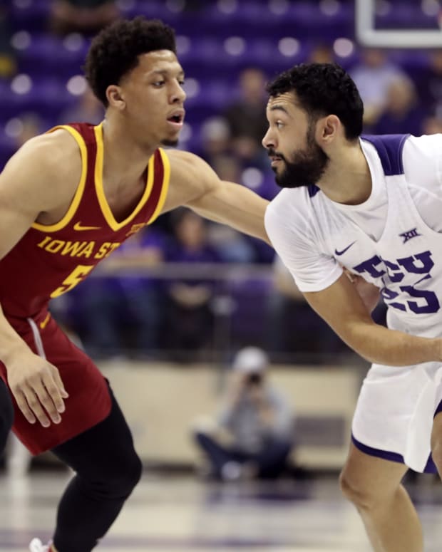 TCU Horned Frogs guard Alex Robinson (25) dribbles as Iowa State Cyclones guard Lindell Wigginton (5) defends during the first half at Ed and Rae Schollmaier Arena.
