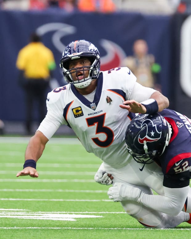 Dec 3, 2023; Houston, Texas, USA;Denver Broncos quarterback Russell Wilson (3) is hit by Houston Texans defensive end Jonathan Greenard (52) after the pass in the second quarter at NRG Stadium. Mandatory Credit: Thomas Shea-USA TODAY Sports