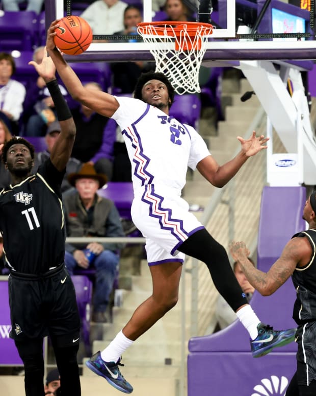 Mar 9, 2024; Fort Worth, Texas, USA; TCU Horned Frogs forward Emanuel Miller (2) catches the ball in front of UCF Knights forward Ibrahima Diallo (11) during the second half at Ed and Rae Schollmaier Arena.
