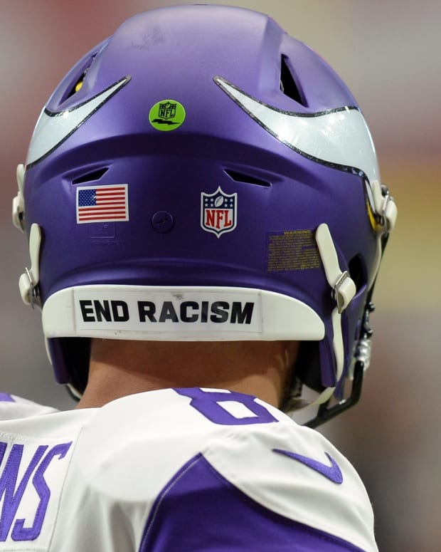 Sep 19, 2021; Glendale, Arizona, USA; An END RACISM sticker is shown on the helmet of Minnesota Vikings quarterback Kirk Cousins (8) prior to the game against the Arizona Cardinals at State Farm Stadium.