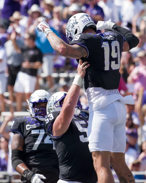 Sep 23, 2023; Fort Worth, Texas, USA; TCU Horned Frogs offensive lineman John Lanz (53) and tight end Jared Wiley (19) celebrates after Wiley scores a touchdown against the SMU Mustangs during the first half at Amon G. Carter Stadium.