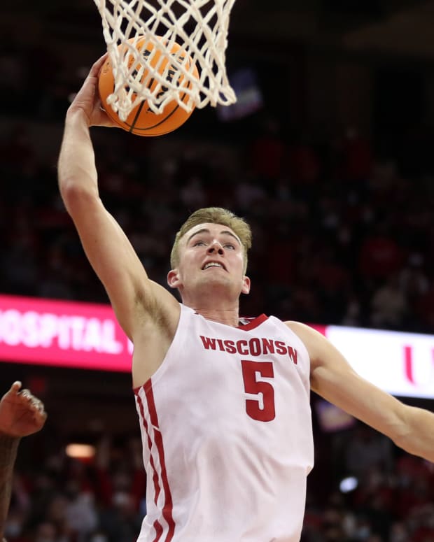 Wisconsin forward Tyler Wahl dunking the basketball inside the Kohl Center (Credit: Mary Langenfeld-USA TODAY Sports)