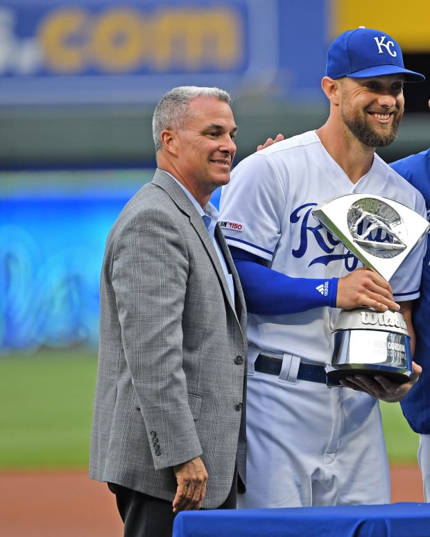 Apr 13, 2019; Kansas City, MO, USA; Kansas City Royals left fielder Alex Gordon (center) receives the Defensive Player of the Year Award from General Manager Dayton Moore (left) and manager Ned Yost (right), prior to the start of the game against the Cleveland Indians at Kauffman Stadium. Mandatory Credit: Peter G. Aiken/USA TODAY Sports