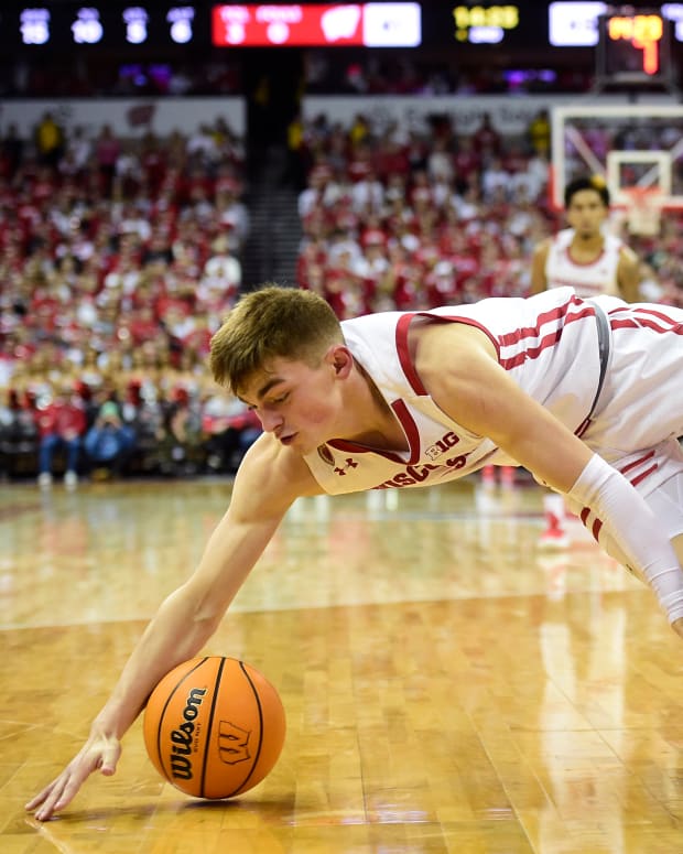 Wisconsin guard Connor Essegian diving for the basketball against Wake Forest.