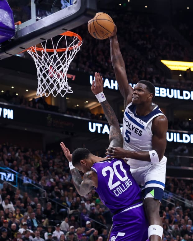 Minnesota Timberwolves guard Anthony Edwards (5) dunks the ball against Utah Jazz forward John Collins (20) during the third quarter at Delta Center in Salt Lake City on March 18, 2024.