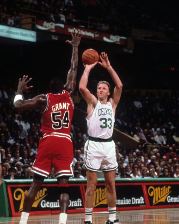 Boston Celtics forward Larry Bird shoots over Chicago Bulls forward Horace Grant at the Boston Garden