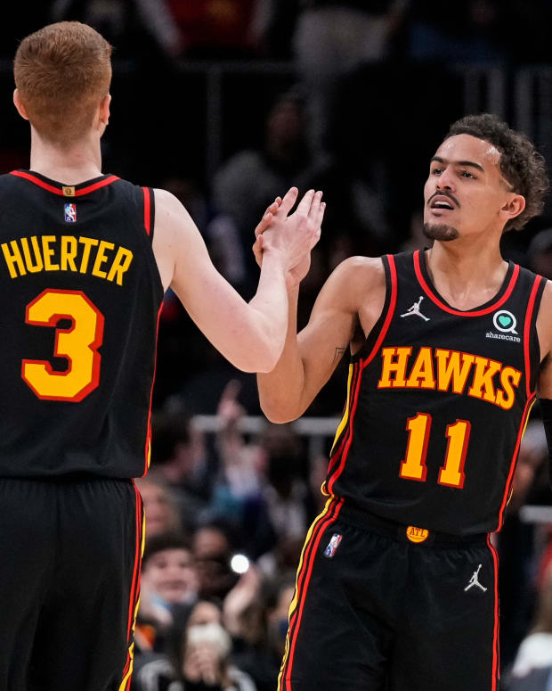 Jan 21, 2022; Atlanta, Georgia, USA; Atlanta Hawks guard Kevin Huerter (3) reacts with guard Trae Young (11) after making a three point shot against the Miami Heat during the second half at State Farm Arena.