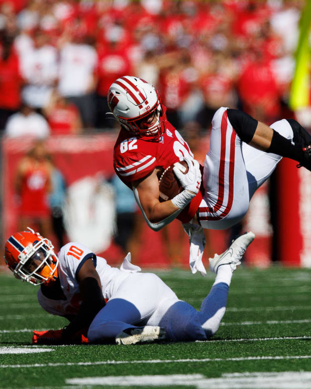 Wisconsin tight end Jack Eschenbach is tackled in the open field against Illinois.