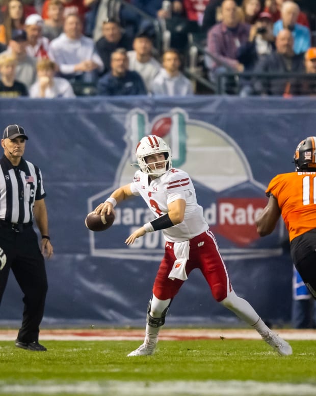 Chase Wolf throwing the ball side arm against Oklahoma State in the Guaranteed Rate Bowl.