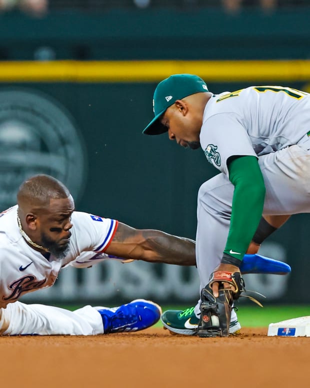 Jul 12, 2022; Arlington, Texas, USA; Texas Rangers right fielder Adolis Garcia (53) steals second base ahead of the tag by Oakland Athletics shortstop Elvis Andrus (17) during the fourth inning at Globe Life Field. Mandatory Credit: Kevin Jairaj-USA TODAY Sports