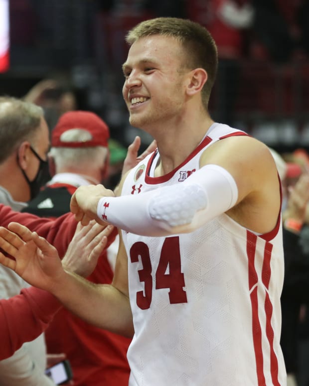 Wisconsin guard Brad Davison interacting with fans after a win at the Kohl Center (Credit: Mary Langenfeld-USA TODAY Sports)