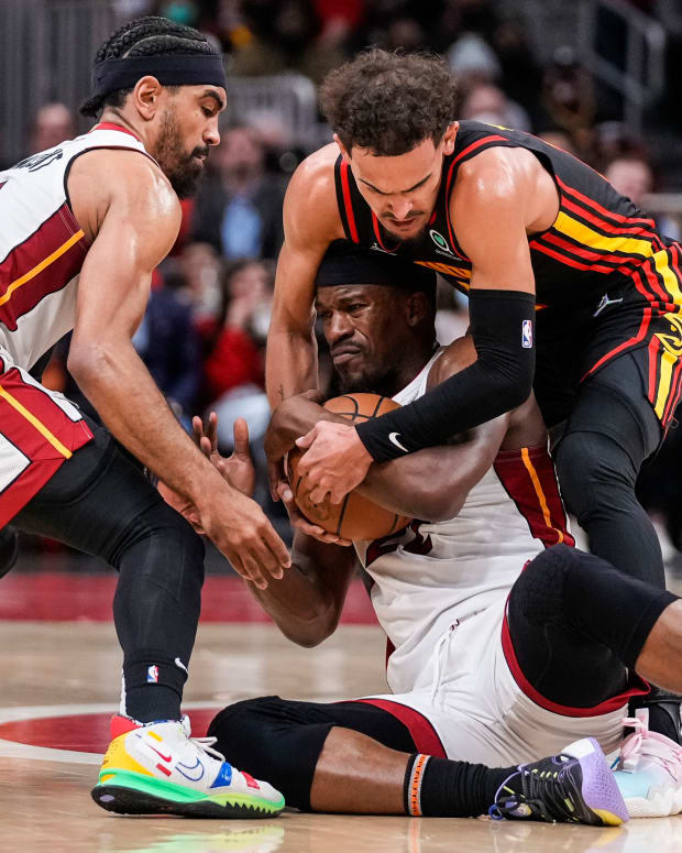 Jan 21, 2022; Atlanta, Georgia, USA; Miami Heat forward Jimmy Butler (22) and Atlanta Hawks guard Trae Young (11) fight for the ball on the court during the second half at State Farm Arena.