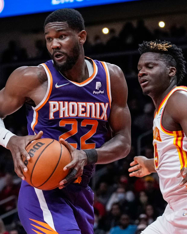Feb 3, 2022; Atlanta, Georgia, USA; Phoenix Suns center Deandre Ayton (22) controls a rebound in front of Atlanta Hawks center Clint Capela (15) during the first half at State Farm Arena.