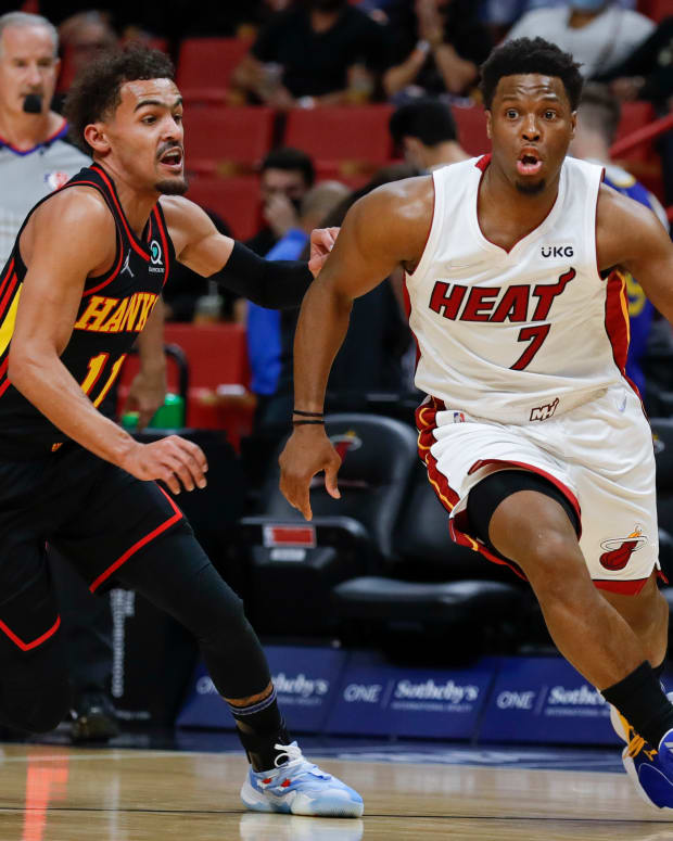 Jan 14, 2022; Miami, Florida, USA; Miami Heat guard Kyle Lowry (7) dribbles the ball around Atlanta Hawks guard Trae Young (11) during the first quarter of the game at FTX Arena.