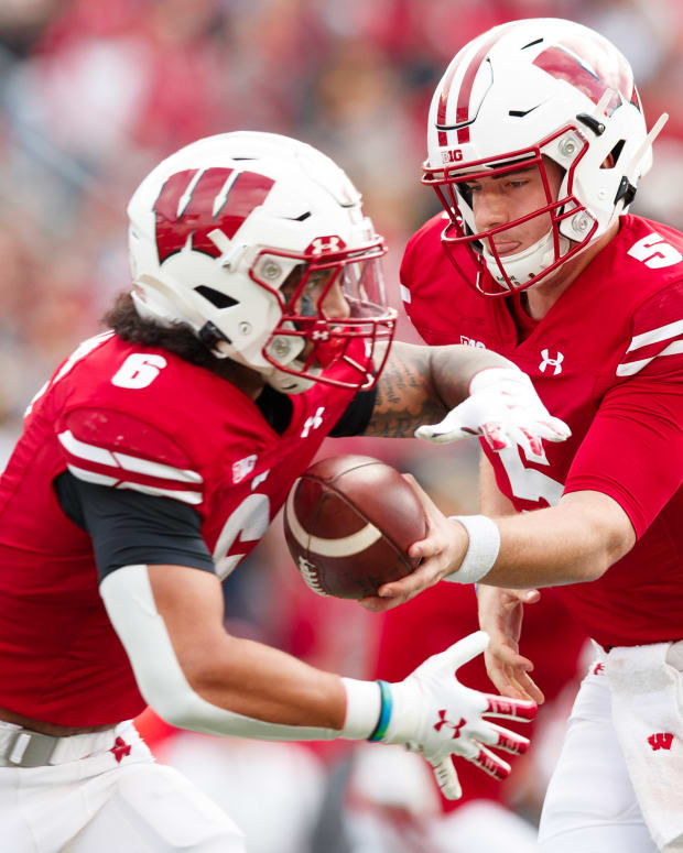 Wisconsin running back Chez Mellusi taking a carry from Graham Mertz (Credit: Jeff Hanisch-USA TODAY Sports)