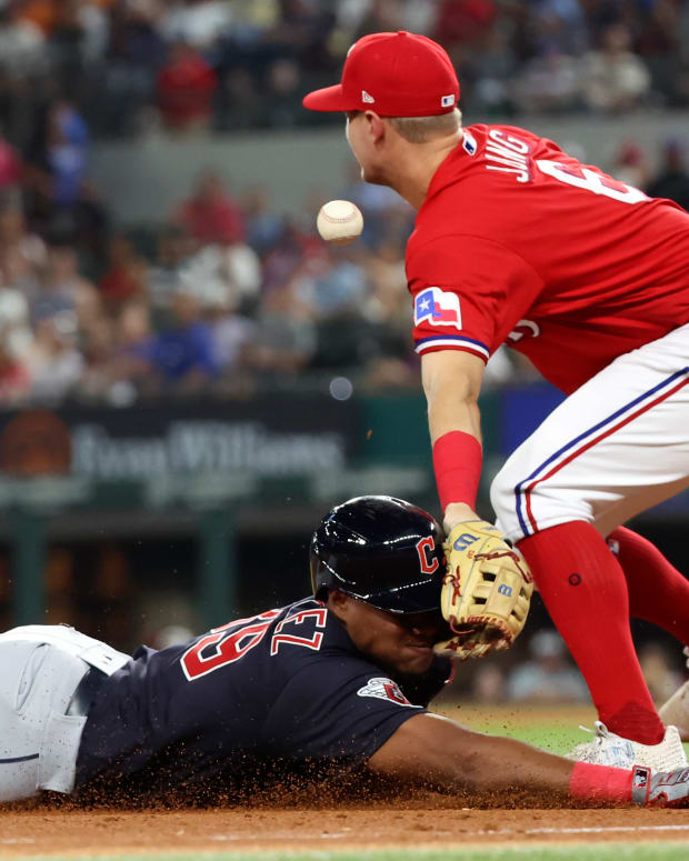 Sep 23, 2022; Arlington, Texas, USA; Texas Rangers third baseman Josh Jung (6) hits Cleveland Guardians designated hitter Oscar Gonzalez (39) in the face with his glove while trying to field a throw during the sixth inning at Globe Life Field. Mandatory Credit: Kevin Jairaj-USA TODAY Sports
