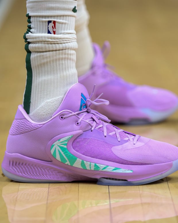 View of purple and green Nike shoes.