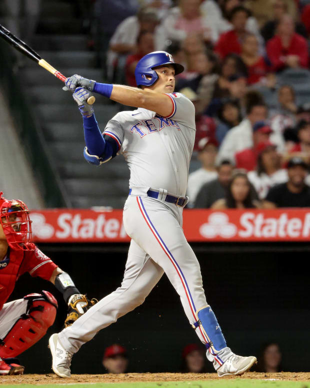 Oct 1, 2022; Anaheim, California, USA; Texas Rangers first baseman Nathaniel Lowe (30) hits a two-run home run during the seventh inning against the Los Angeles Angels at Angel Stadium. Mandatory Credit: Kiyoshi Mio-USA TODAY Sports