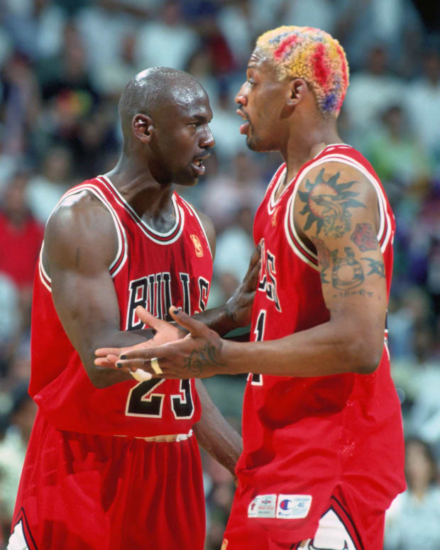 Chicago Bulls forward #91 DENNIS RODMAN is held back from the official by guard #23 MICHAEL JORDAN against the Miami Heat at the Miami Arena during the 1996-97 season.