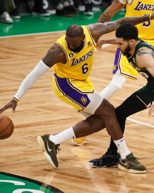 Celtics forward Jayson Tatum defends Lakers forward LeBron James.