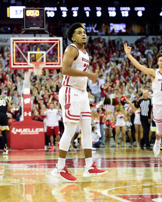 Wisconsin guard Chucky Hepburn and teammates celebrate a half-court shot just before halftime.