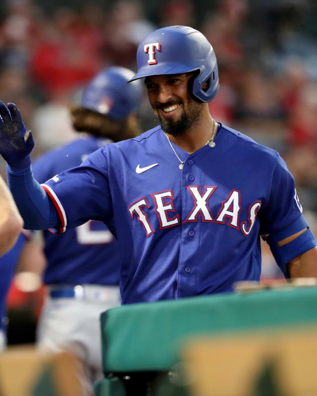 Jul 29, 2022; Anaheim, California, USA; Texas Rangers shortstop Marcus Semien (2) congratulated by a teammate after scoring a run in the sixth inning against the Los Angeles Angels at Angel Stadium. Mandatory Credit: Kiyoshi Mio-USA TODAY Sports