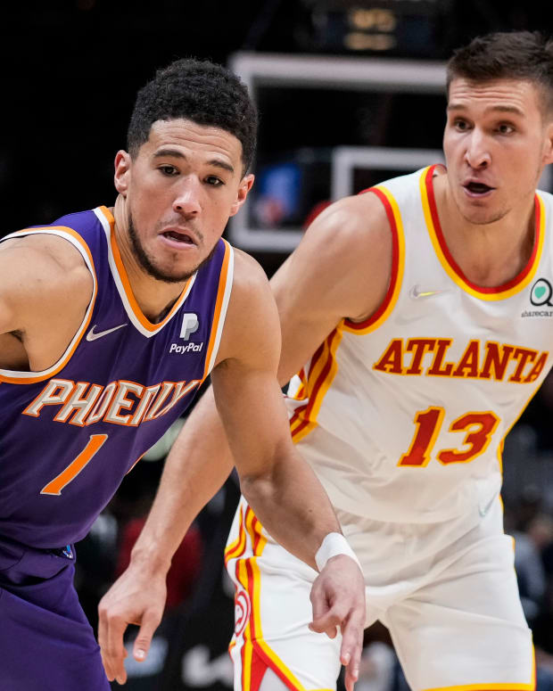 Phoenix Suns guard Devin Booker goes after the ball behind Atlanta Hawks guard Bogdan Bogdanovic. The Suns face the Hawks twice in the 2022-23 NBA season.